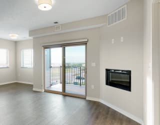 The 2 bedroom Marigold with den floor plan at WH Flats features natural light and a spacious dining and living area with electric fireplace.