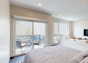 Thumbnail 7 of 11 - a studio apartment with a large bed and a tv on the wall