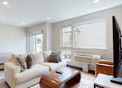 Thumbnail 9 of 11 - a living room with a couch and a tv