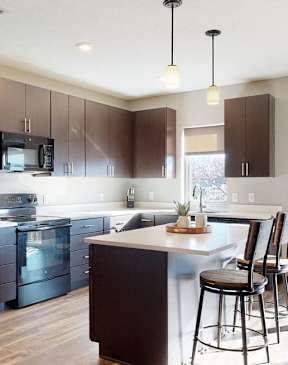 Furnished apartment kitchen with dark finish style and all black kitchen appliances