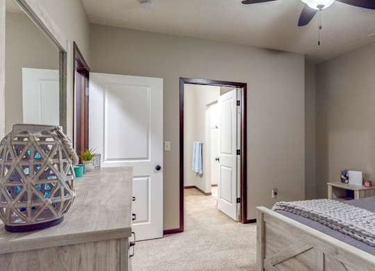 The master bedroom features an attached bathroom and spacious closet in the Cedar floor plan