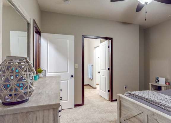 The master bedroom features an attached bathroom and spacious closet in the Cedar floor plan