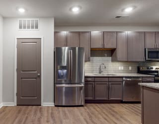 This 2 bedroom Hibiscus floor plan features an open kitchen with neutral gray cabinets, light granite countertops, and a large pantry.