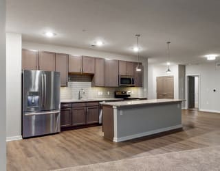 The 2 bedroom Hibiscus floor plan at WH Flats features an open spacious kitchen area with granite countertops and large island.