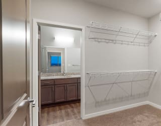 The master bedroom in the Hibiscus floor plan features a spacious walk-in closet.
