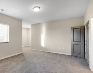 The large bedroom with den area in the 2 bedroom Marigold with den floor plan is perfect for a desk or reading nook.