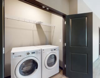 A washer and dryer are included in the 2 bedroom Snowdrop with den floor plan at WH Flats
