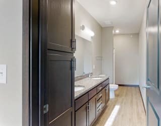 The master bathroom in the Snowdrop with den floor plan features dual vanity with large shower.