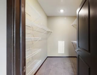 You'll love the large walk-in closet in the master bedroom of the Snowdrop with den floor plan at WH Flats.