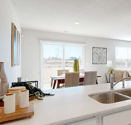 a kitchen with a sink and a view of a living room