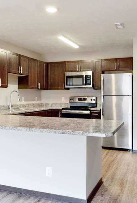 Renovated kitchen with granite counters and new appliances at Northridge Heights Apartments