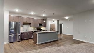 The 2 bedroom Hibiscus floor plan at WH Flats features an open spacious kitchen area with granite countertops and large island.