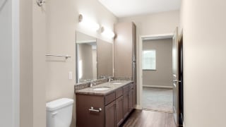 The master bathroom in the Marigold with den floor plan features dual vanity with large shower.