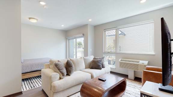 a living room with a couch and a tv