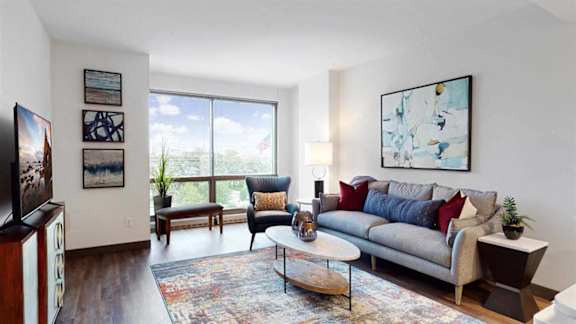 a living room with a couch and a large window