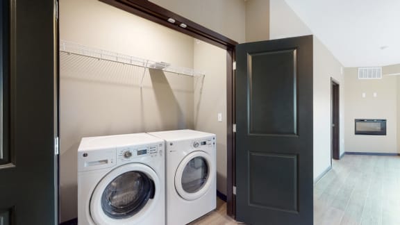 A washer and dryer are included in the 2 bedroom Snowdrop with den floor plan at WH Flats
