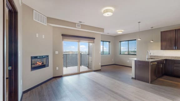 The 2 bedroom Snowdrop with den floor plan at WH Flats features natural light and a spacious dining and living area with electric fireplace.