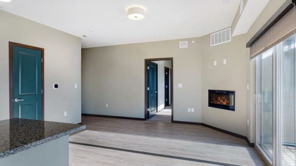 The 2 bedroom Snowdrop with den floor plan at WH Flats features natural light and a spacious dining and living area with electric fireplace.
