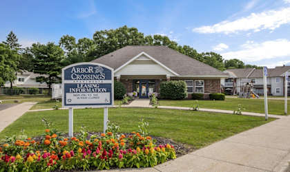 a church with a sign in front of a house
