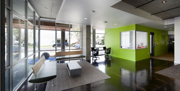 A room with a green wall and a bench.