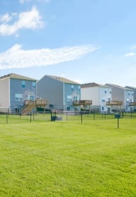 a group of houses in a fenced in yard