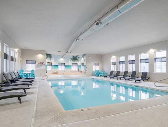 Indoor Saltwater Swimming Pool with lounge seating at Cascade Pines Duplex Homes in Lincoln NE