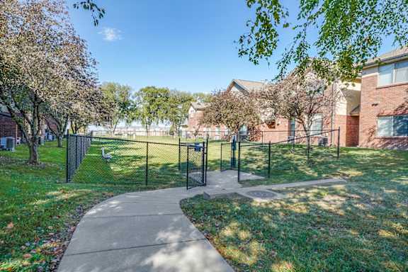 A playground with a swing set and a slide in a park.