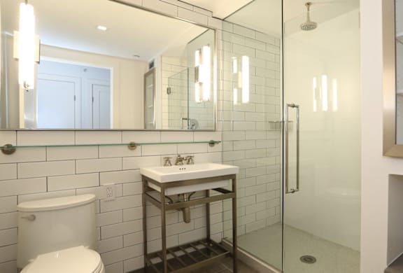 A white toilet sits next to a sink in a bathroom.