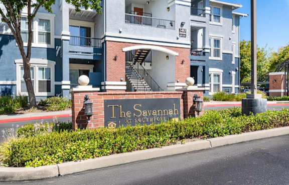 The Savannah at Southridge is a multi-story residential building with a blue and white exterior.