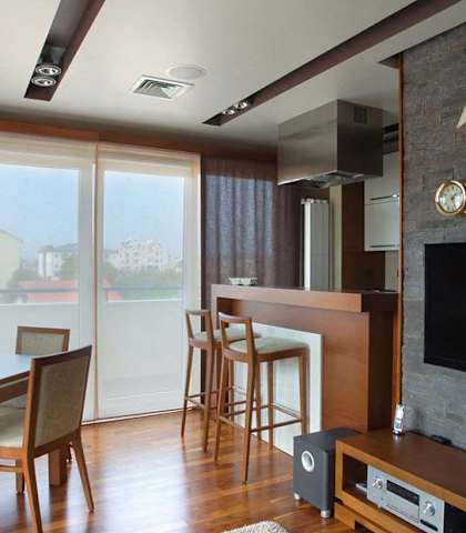 a living room with a tv and a table and chairs