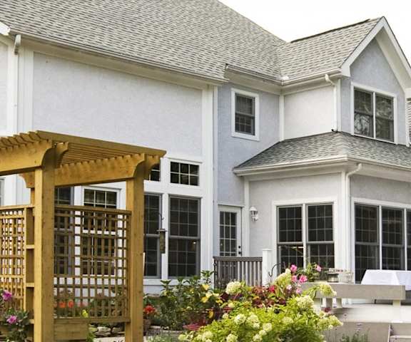 the outside of a house with a patio and a porch