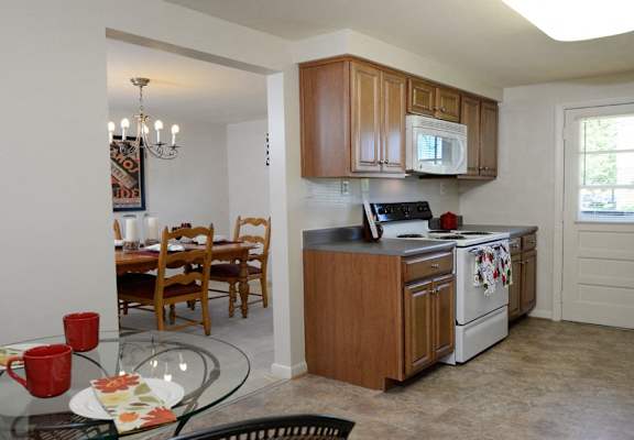 A kitchen with a table set for two.