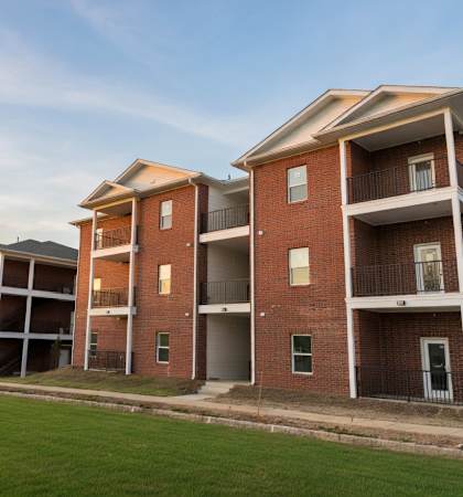 Apartment buildings with green lawns in front.