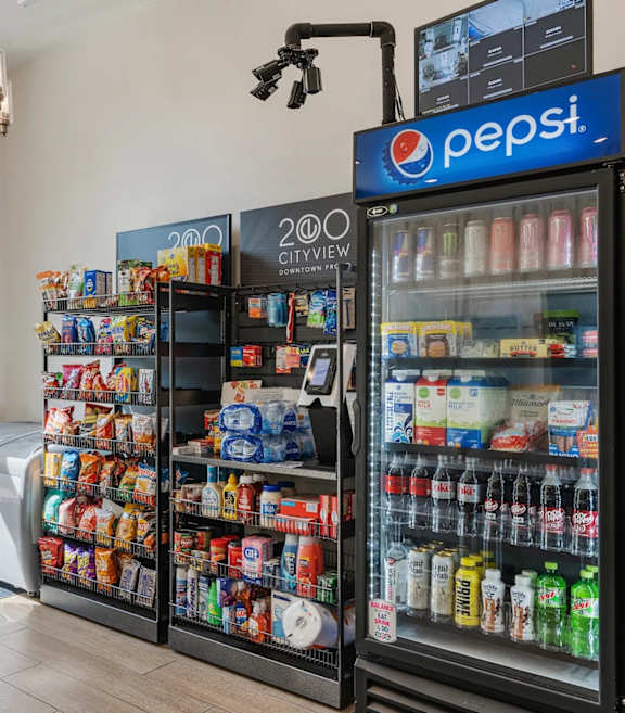 A Pepsi vending machine with a variety of drinks and snacks.