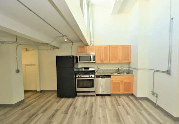 a kitchen with a stove top oven next to a refrigerator