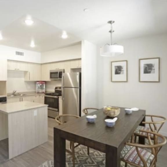 a kitchen and dining room with a table and chairs