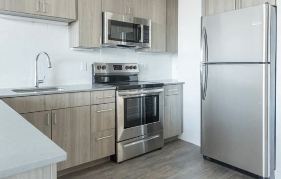 a kitchen with stainless steel appliances and wooden cabinets