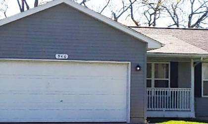 a gray house with a white garage door