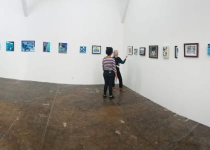 people looking at artwork in an exhibition