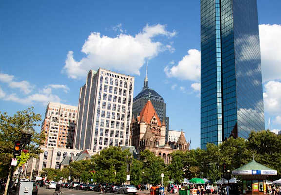 A city street with a large building in the background.