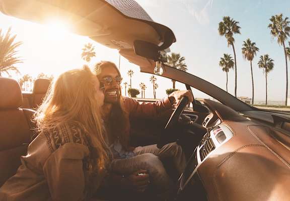 couple driving at sunset at Laguna Pointe, Pompano Beach
