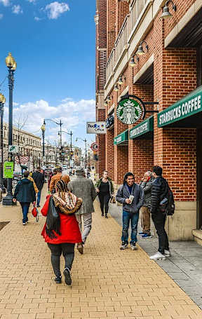 people walking down a city street in front of a brick building at The Argonne Apartments, Washington, DC, 20009