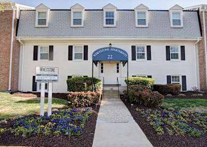 a white building with a blue sign that says welcome