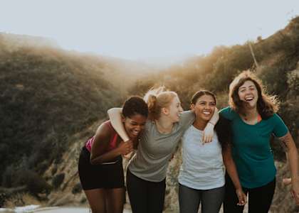 a group of women walking in the mountains