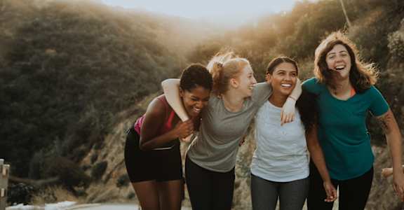 a group of women walking in the mountains