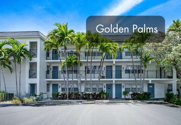 A building with the name Golden Palms on a sign in front of it.
