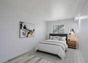 Thumbnail 5 of 20 - A bedroom with a large bed and a painting on the wall.