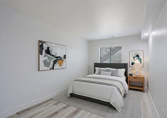 A bedroom with a large bed and a painting on the wall.