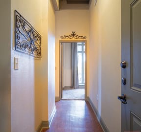 a hallway with a door and a mirror on the wall