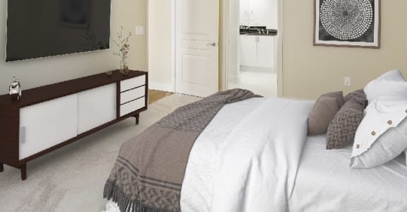 a bedroom with a bed and a television on the wall at The Mark at Dulles Station, Herndon